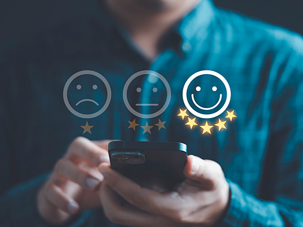 person using phone to select happy or sad faces